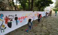 برپایی ایستگاه نقاشی دیواری کودکان در سنندج به روایت تصویر